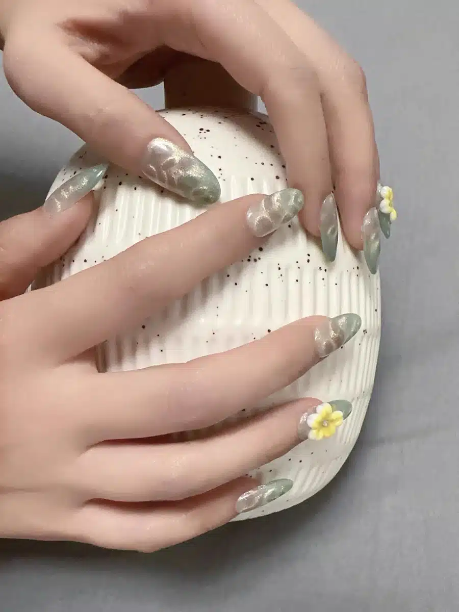 Close up of mint green sea wave texture and cat eye shimmer on nails 2.jpg 1 Image #1 from Emily S.